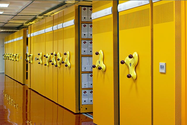 A row of red storage facilities, securely closed and locked 