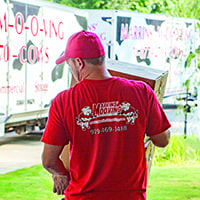 marrins' moving mover lifting boxes onto a porch